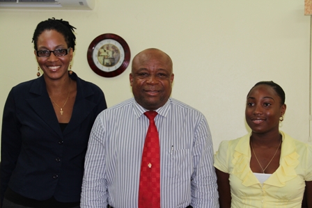 Minister of Youth and Health in the Nevis Island Administration Hon. Hensley Daniel at the ceremony to announce the winners of the Nevis Island Administration/Medical University of the Americas Health Science Scholarships (middle) flanked by Ms. Kamara Louisy (l) and Ms. Earline Pemberton (r)