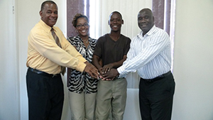 (L-R) Permanent Secretary in the Ministry of Agriculture on Nevis Eric Evelyn, Earth University scholarship holders Devene Smithen and Prince Arrindell with Minister of Agriculture on Nevis Hon. Alexis Jeffers at his Charlestown office on August 11, 2014