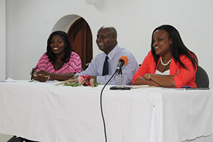 (L-R) Chairperson at the opening ceremony of the Nevis Public Library’s 8th annual International College Fair Shariska Browne, Permanent Secretary in the Premier’s Ministry Mr. Wakely Daniel and Featured Speaker Ms. Kerrilyn Edwards sitting at head table on November 17th, 2014, at the Nevis Public Library’s 8th annual International College Fair, at the St. Paul’s Anglican Parish Hall