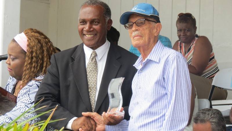 Premier of Nevis Hon Vance Amory presenting Arthur Evelyn with his award at the Gulf Insurance Inter-Primary Schools Championship Opening Ceremony Elquemedo T. Willett Park on April 01, 2015