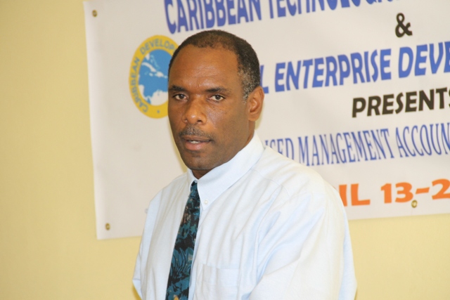 Permanent Secretary in the ministry of Finance Colin Dore delivering remarks at the opening ceremony of the Caribbean Development Bank Management Accounting Systems for MSMEs eight-day workshop on April 13, 2015 at the Ministry of Education’s Conference Room