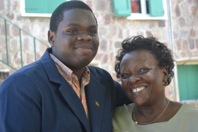 Rol-J Williams warmly embraces his mother Mrs. Janice Williams moments after he was honoured by Nevis Island Assembly President and Premier of Nevis Hon. Vance Amory at the Assembly grounds on August 05, 2015, for his achievement as a Youth Parliamentarian at the recent 40th Caribbean Parliamentary Association’s (CPA) Caribbean, Americas and Atlantic Region's Conference in Tortola, British Virgin Islands