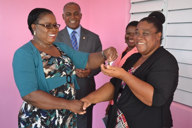 Mrs. Florence Smithen, Education Officer responsible for Early Childhood Education in the Department of Education, hands over the keys to the newly renovated and expanded Gingerland Preschool to Supervisor Mrs. Pamella Elliott-Lawrence on December 12, 2017, while Hon. Vance Amory, Premier of Nevis and Minister of Education and Mrs. Palsy Wilkin, Principal Education Officer in the Department of Education look on
