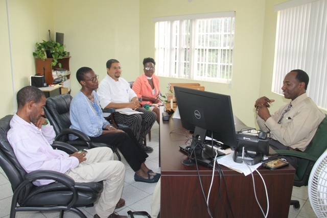 (l-r) Mr. Ian Chapman, Food and Agriculture Organisation National Correspondent on St. Kitts and Nevis, Dr. Isabella Granderson, a lecturer at the University of the West Indies St. Augustine’s Campus and consultant to the Food and Agriculture Organization, Mr. Michael Henville, Executive Chef and Food and Nutrition Specialist attached to the School Meals Programme and Ms. Earlene Maynard, Director of the School Meals Programme with Mr. Kevin Barrett, Permanent Secretary in the Ministry of Education at his Marion Heights Office on January 18, 2018