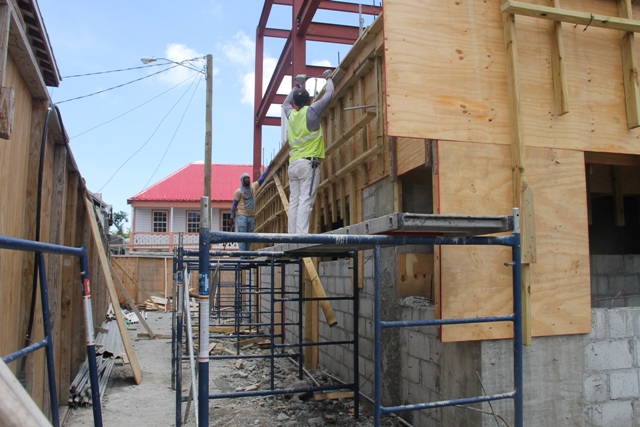 Local masons working on the first floor of the new Treasury building under construction in Charlestown on April 10, 2018