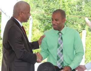 : Hon. Spencer Brand, Minister of Water Services on Nevis hands over keys to the pump station and wells at Maddens Estate to Mr. Roger Hanley, Manager of the Nevis Water Department, moments after receiving it from Mr. Michael Miville, Chief Executive Officer, of Bedrock Exploration and Development Technologies LLC at a handing over ceremony on October 05, 2018