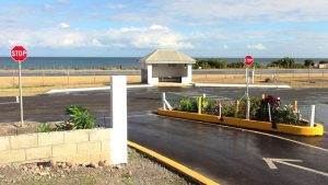 Traffic signs and a planter with flowers erected at the entrance of Shaws Road in Newcastle
