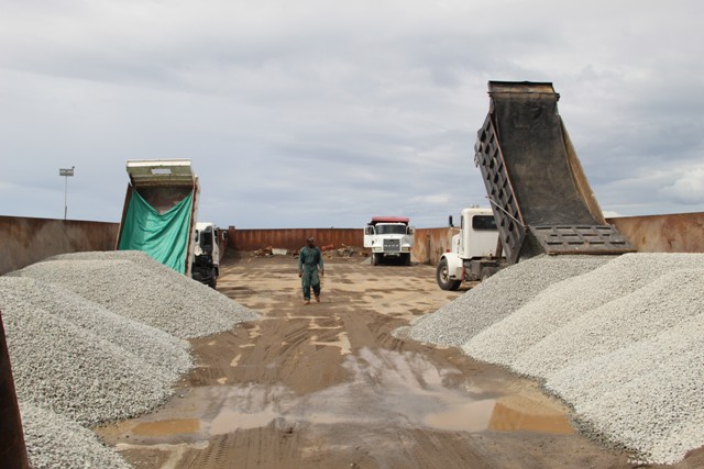 Truckers loading barge at Long Point Port bound for St. Kitts with aggregate from the government owned quarry at New River on January 16, 2019