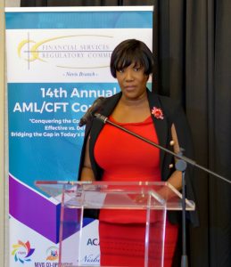 Photo caption: MS. Heidi-Lynn Sutton, Regulator, Financial Services Regulatory Commission – Nevis Branch, gives welcoming remarks during the Opening Ceremony of the 14th Annual AML/CFT Conference on March 11, 2019 at the Four Seasons Resort Nevis