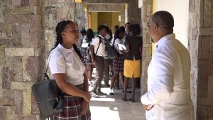 Mr. Samuel Berridge, Senior Foreign Service Officer in the Ministry of Foreign Affairs, speaks with a student of the Nevis Sixth Form College at the Nevis Performing Arts Centre, during Diplomatic Week 2019