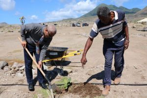 Hon. Spencer Brand, Minister responsible for the Environment, plants a Sea Grape tree at the Nevis Historical Conservation Society’s New River Coconut Walk Restoration Project on April 23, 2019 with assistance from Mr. Keithley Amory, Project Coordinator 