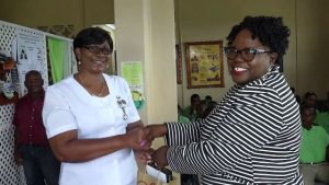 (L-r) Averil Walters, Community Health Nurse at the Gingerland Health Centre, one of 116 nurses receiving a token of appreciation from Hon. Hazel Brandy-Williams, Junior Minister of Health on Nevis, on May 13, 2019
