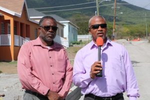 Hon. Spencer Brand, Minister of Communication and Works (left), accompanied by Mr. Denzil Stanley, Assistant Permanent Secretary in the Ministry of Communication and Works, speaking to the Department of Information during a sight visit to the Craddock Road Rehabilitation Project on July 24, 2019