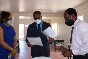 The incumbent Mr. Mark Brantley of the Concerned Citizens Movement accompanied by his wife Sharon, examines his nomination documents from the Returning Officer at the Bath Community Centre was Mr. Kevin Barrett (r) during his nomination on May 27, 2020, to contest the general elections in Constituency No.9 on June 05, 2020