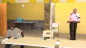 Hon. Eric Evelyn, Minister of Social Development on Nevis (left), delivering remarks at a retirement ceremony at the Nevis Performing Arts Centre courtyard on May 8, 2020, hosted by the ministry for Mr. Alsted Pemberton, outgoing Director of the Social Policy and Sustainable Human Development Unit (right)