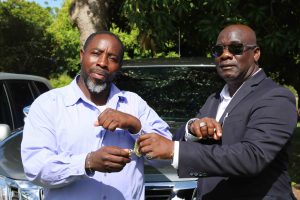 Hon. Alexis Jeffers, Deputy Premier and Minister of Agriculture, hands over the keys to a vehicle to Mr. Floyd Liburd, Assistant Director in the Department of Agriculture on July 21, 2020, at the Prospect Agricultural Station
