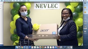 Ms. Joy Napier, Principal of the Nevis International High School, receiving a laptop from Ms. Hazel Chiverton, Chairperson of the Nevis Electricity Company Limited’s 20th Anniversary Organising Committee, at a handing over ceremony at the company’s board room on August 26, 2020