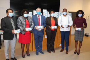 Dr. Sandeep Kacker, Assistant Dean of the Medical University of the Americas; Hon. Hazel Brandy-Williams, Junior Minister of Health in the Nevis Island Administration; Dr. Ralph Crum, Dean of the Medical University of the Americas; Dr. Judy Nisbett, Chairperson of the Nevis COVID-19 Task Force; Hon. Mark Brantley, Premier of Nevis and Senior Minister of Health; and Ms. Shelisa Martin-Clarke, Permanent Secretary in the Ministry of Health, at a handing over ceremony of 100,000 masks at the Emergency Operations Centre at Long Point on September 08, 2020