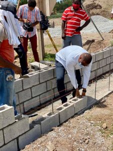 (l-r) Hon. Mark Brantley, Premier of Nevis lays a concrete block at the construction site during a tour of the St. Kitts and Nevis Pinney’s Beach Park Project on September 15, 2020