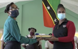 (l-r) Mrs. Lineth Williams, Principal of the Gingerland Secondary School accepting school supplies from Ms. Latoya Jeffers, Education Officer responsible for the Gingerland Secondary School during a presentation of school supplies donated by Hon. Eric Evelyn, Minister of Youth and Community Development in the Nevis Island Administration, and area representative for St. George’s, Gingerland on October 09, 2020