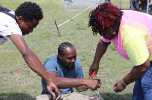 Hon. Hazel Brandy-Williams, Junior Minister of Health and Gender Affairs in the Nevis Island Administration interacting with participants at the Department of Gender Affairs’ Fish Trap Making Workshop for boys and young men at the Jessups Playing Field on May 08, 2021