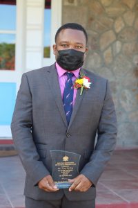 Independence Day honoree Mr. Troy McKoy with his plaque in honour of his 25-year contribution to Business on Nevis following an awards ceremony at Government House on September 20, 2021, on the occasion of the 38th Anniversary of Independence of St. Christopher and Nevis