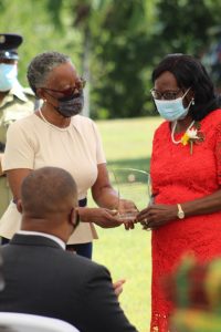Her Honour Mrs. Hyleeta Liburd, Deputy Governor General on Nevis, presenting Independence Day honoree retired registered nurse Mrs. Ernette Manners with a plaque at an awards ceremony at Government House on September 20, 2021