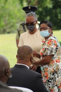Her Honour Mrs. Hyleeta Liburd, Deputy Governor General of Nevis, presenting a plaque to Ms. Christiana Smith of Fountain Village at an awards ceremony at Government House on September 20, 2021, while Hon. Mark Brantley, Premier of Nevis, looks on