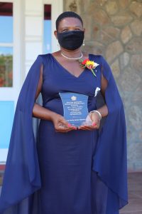 Mrs. Palsy Wilkin showing off her award after receiving the plaque from Her Honour Mrs. Hyleeta Liburd, Deputy Governor General on Nevis after an Awards Ceremony at Government House on September 20, 2021, in honour of her sterling contribution to Education in St. Kitts and Nevis on the occasion of the Federation's 38th Anniversary of Independence