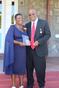 Independence Day Awardee Mrs. Palsy Wilkin with her husband Mr. Pearlievan Wilkin after receiving a plaque from Her Honour Mrs. Hyleeta Liburd, Deputy Governor General on Nevis, at an Awards Ceremony at Government House on September 20, 2021, in honour of her sterling contribution to Education in St. Kitts and Nevis on the occasion of the Federation's 38th Anniversary of Independence