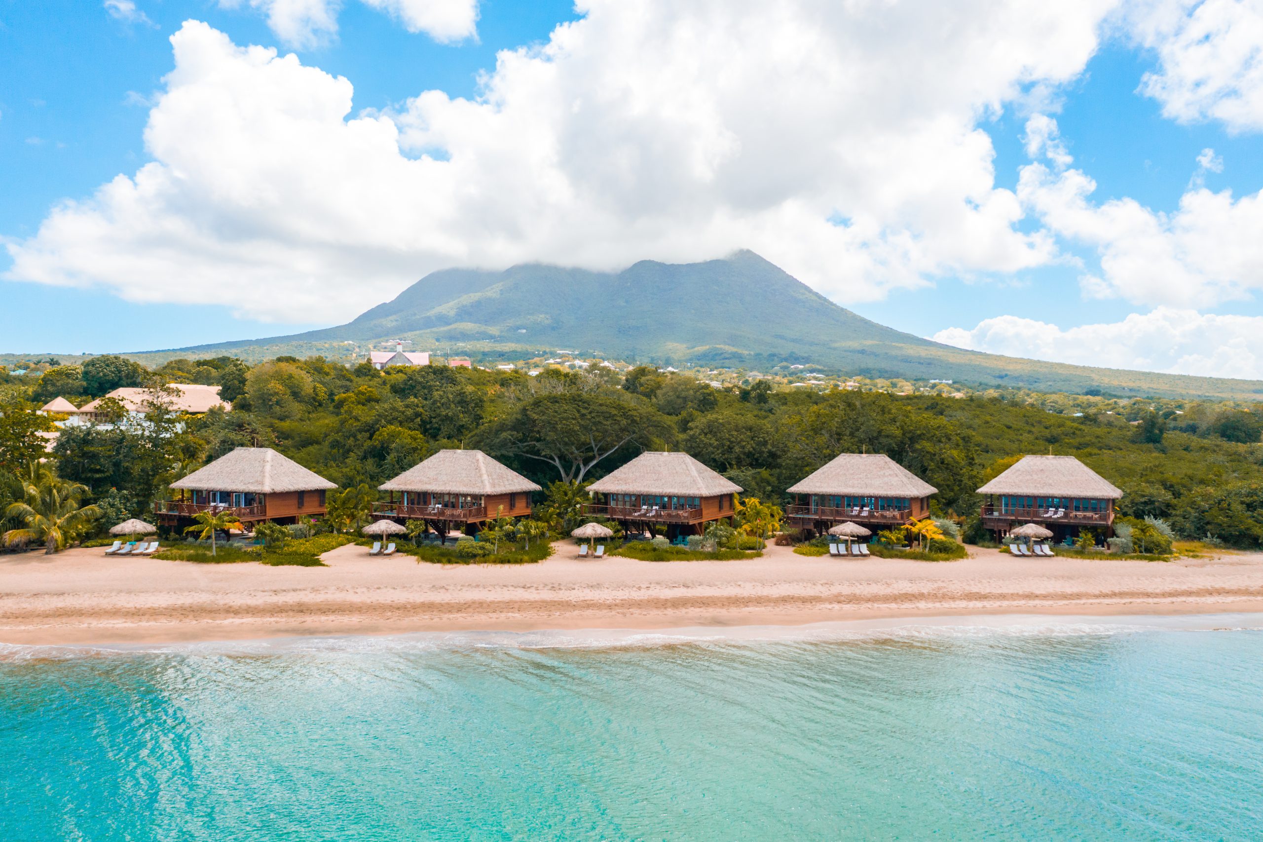 The Caribbean Sea lapping the beach at Paradise Estates with Nevis Peak in the background (photo provided)