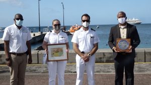 (L-r) Mr. Devon Liburd, Director of Sales and Marketing at the Nevis Tourism Authority; crew member Anastasia and Staff Captain Daniel of the MV World Voyager; and Hon. Spencer Brand who is representing Hon. Mark Brantley, Premier of Nevis and Minister of Tourism, at a welcoming ceremony at the Charlestown Port during the vessel’s inaugural call to Nevis on December 17, 2021