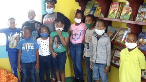 Excited students of the St. James Primary School sample the bean bag experience at the school’s library, a gift from the Butlers Enhancement and Improvement Association on February 04, 2022