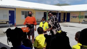 Hon. Hazel Brandy-Williams, Junior Minister of Health and Gender Affairs, with awardee J’sean Pemberton of the Violet O. Jeffers Nicholls Primary School moments after he was presented with his award in observance of International Day of the Boy Child 2022