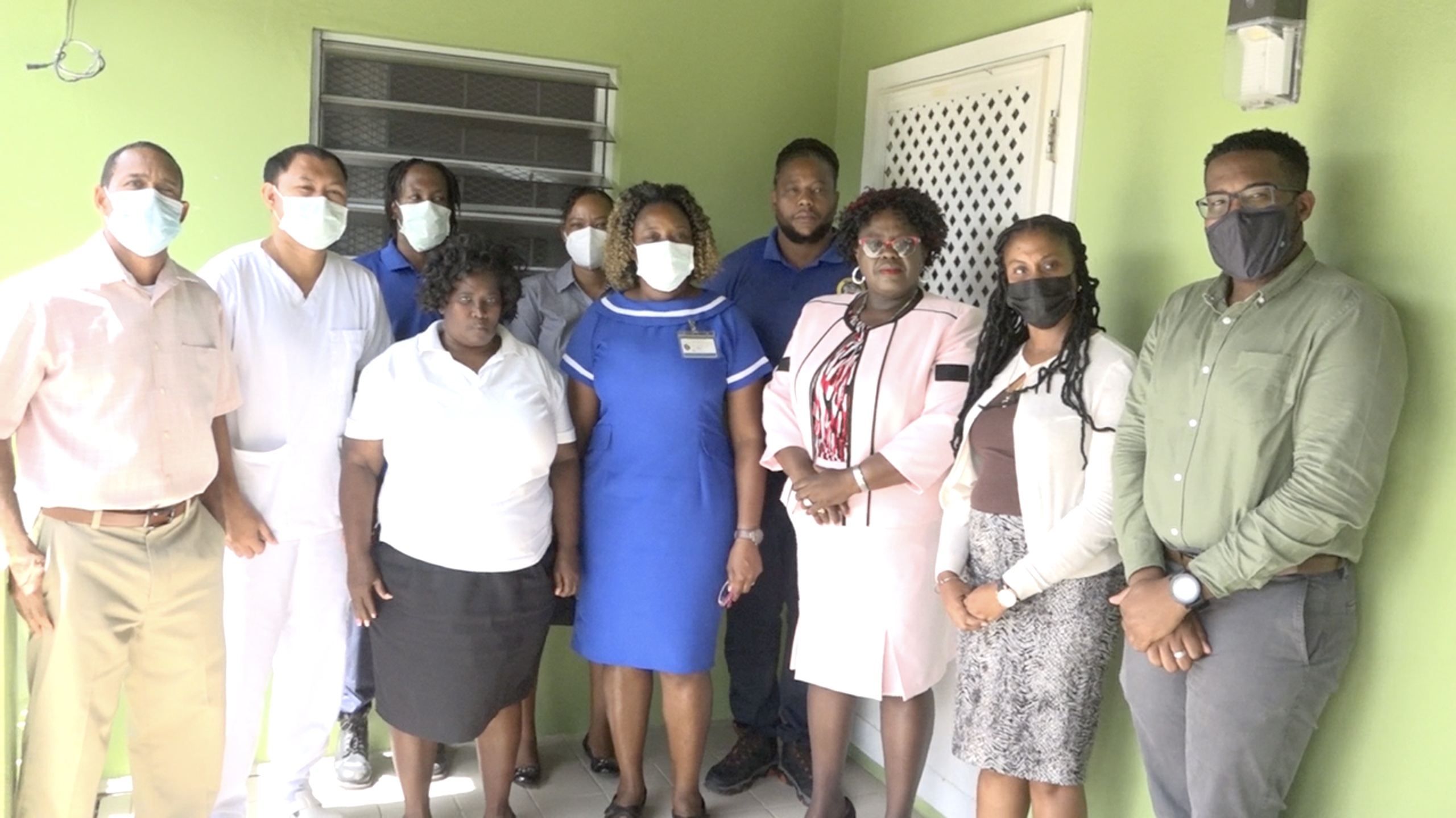 Hon. Hazel Brandy-Williams, Jr. Minister of Health, (third from right) accompanied by Ms. Latoya Jeffers, Assistant Secretary (second from right), with staff at the Mental Health Unit at its new home in Prospect (front row l-r): Mr. McMillan Cuffy, Counsellor; Mr. Ernesto Bruzo, Registered Nurse (Psychiatric Services); Ms. Lydia Allen, Facility Custodian/ Housekeeper; Mrs. Stephanie Rowe-Woodstock, Nursing Attendant; and (extreme right) Mr. Oldain Claxton, Counsellor (back row l-r): Mr. Clive Walters, Orderly and Driver; Mrs. Eren Hanley, Public Health Planner; and Mr. Matthew Husbands, Orderly