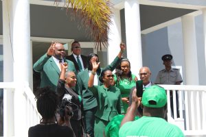 Dr. Daniel-Hodge of the Nevis Reformation Party candidate for Nevis 11 to contest the August 05 National Assembly Elections (middle first row) flanked her witnesses Corrine Hodge of Newcastle village (left) and the Hon. Joseph Parry of Colquhoun Estate (right) moments after her nomination on July 26, 2022 at the Newcastle Police Station with fellow candidates Rohan Isles (second row left) and Dr. Bartlette (to his right) with other party officials and supporters