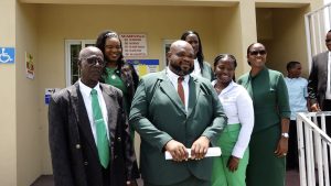 August 05 National Assembly Elections flanked by his witnesses Miguel Mills of Chicken Stone (left) and Tamerelle M. T. Browne of Rawlins Village (right) with fellow candidates and a party official moments after his nomination at the David Freeman Center of Excellence on July 26, 2022