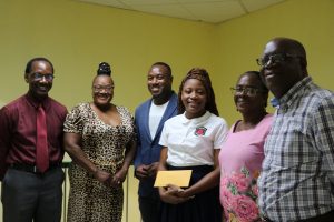 (L-r) Mr. Kevin Barrett, Permanent Secretary in the Ministyr of Education; Mrs. Hyacinth Wallace-Forbes and her son Mr. Eustace Theo Wallace of Hamilton, Minister-Counselor at the St. Kitts and Nevis High Commission to Canada; Ms. Shadé Bridgeman, a student of the Charlestown Secondary School; Ms. Angela Monzac, Head at the Modern Languages Department at the school; and Principal Mr. Juan Williams at a handing over ceremony at the Department of Education on August 30, 2022, for the Wallace Family Bursary