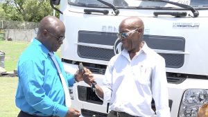 Mr. St. Clair Wallace, Chairman of the Nevis Solid Waste Management Authority’s Board of Directors, hands over keys to new equipment donated by the Nevis Island Administration on September 08, 2022, to Mr. Andrew Hendrickson, the Authority’s General Manager (left), for use at the landfill at Long Point